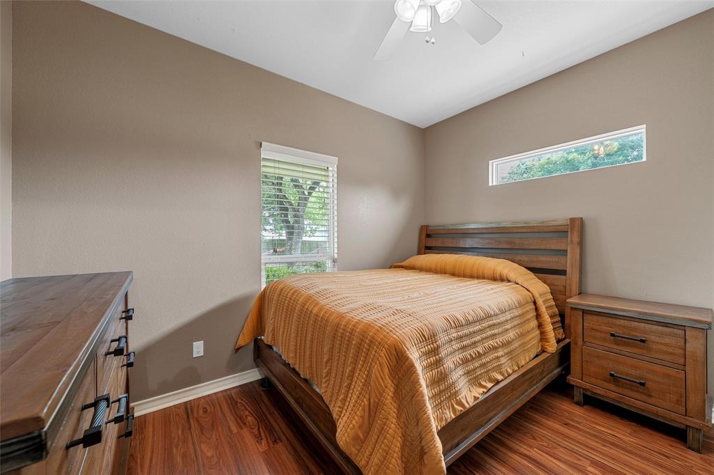 1117 Downsville Road Robinson, TX 76706 - Photo 23 of 40 Bedroom featuring wood-finish flooring, a contemporary ceiling fan with integrated lighting, and neutral wall tones