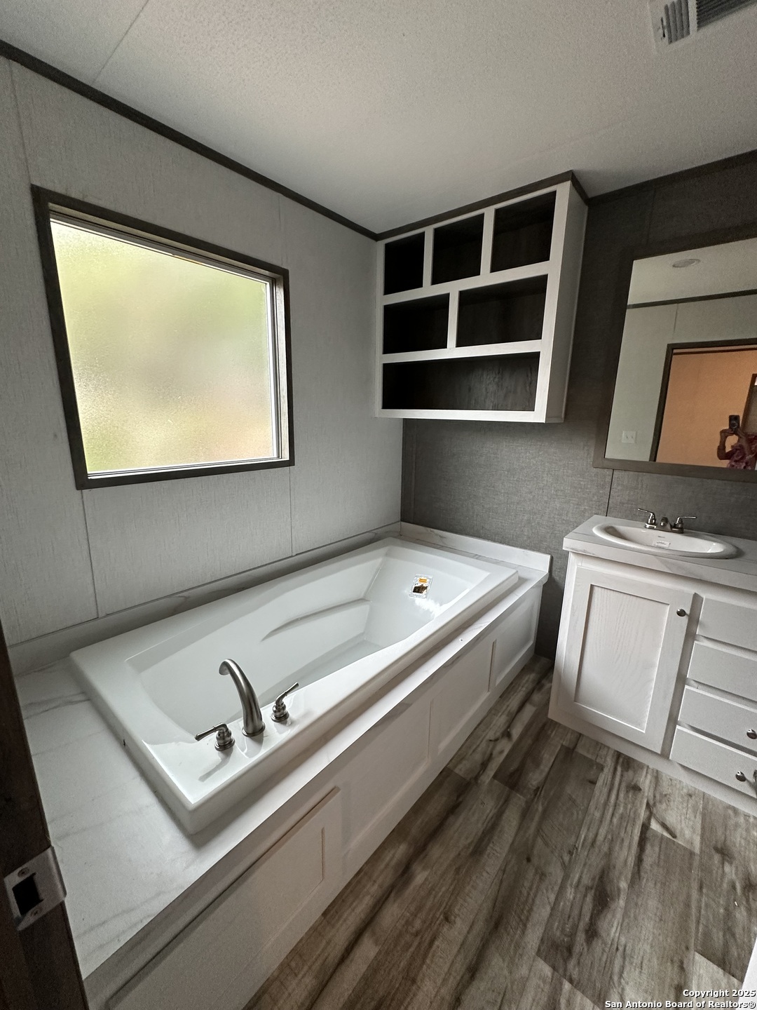 19 Green Meadows Knippa, TX 78870 - Photo 6 of 12 a bathroom with a tub sink and mirror