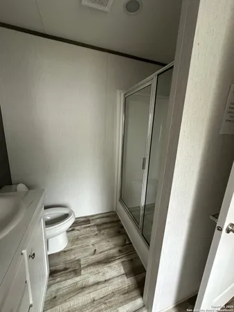 a bathroom with a toilet and a shower