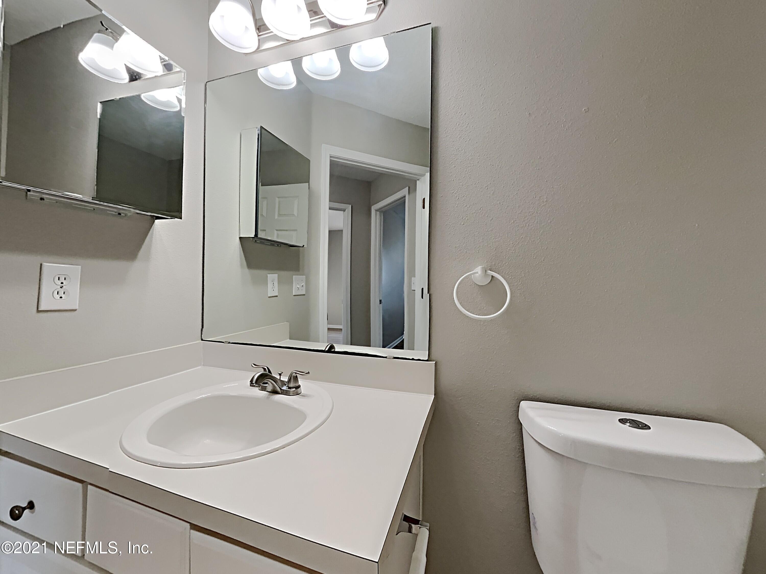 600 Birchbark Trail St. Augustine, FL 32092 - Photo 13 of 16 a bathroom with a sink a toilet and a mirror