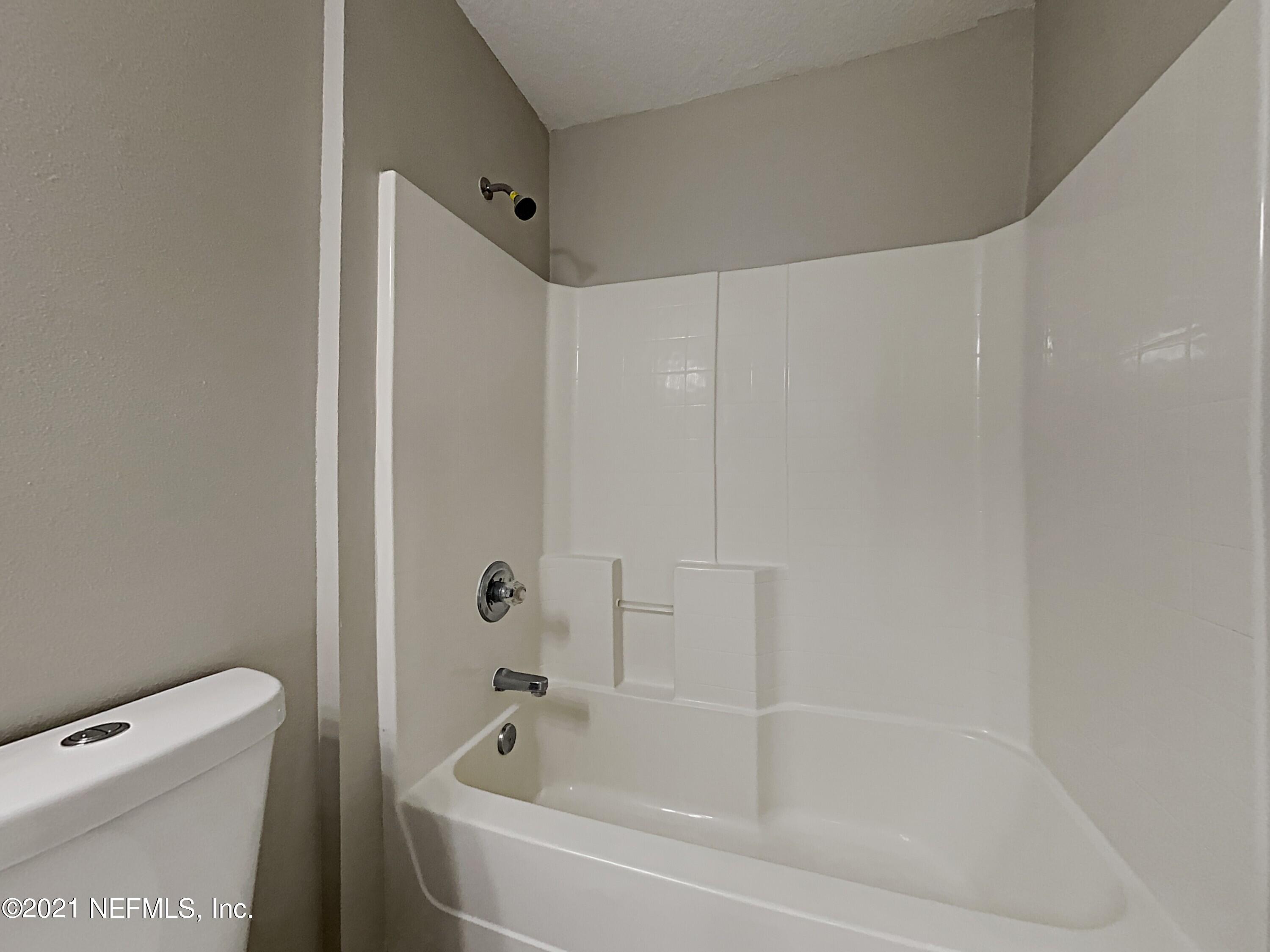 600 Birchbark Trail St. Augustine, FL 32092 - Photo 14 of 16 a white bath tub sitting next to a white toilet and sink