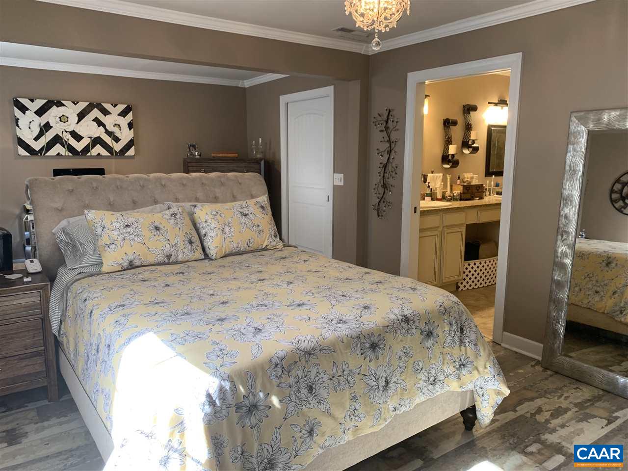 2 Appletree Road Palmyra, VA 22963 - Photo 14 of 49 a bedroom with a large bed and a chandelier