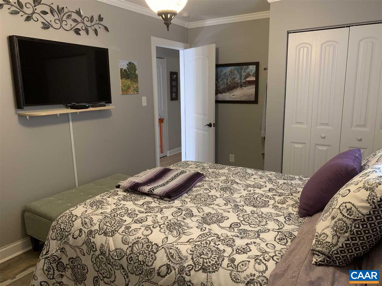 2 Appletree Road Palmyra, VA 22963 - Photo 24 of 49 a bedroom with a bed and a flat screen tv