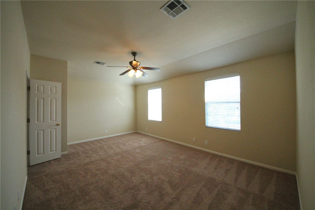 9600 Magna Carta Loop, Unit 177 Austin, TX 78754 - Photo 17 of 25 an empty room with windows and chandelier fan