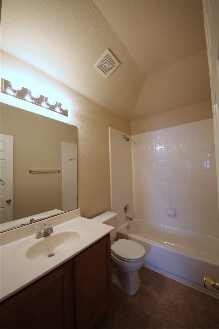 9600 Magna Carta Loop, Unit 177 Austin, TX 78754 - Photo 20 of 25 a bathroom with a double vanity sink toilet and a mirror