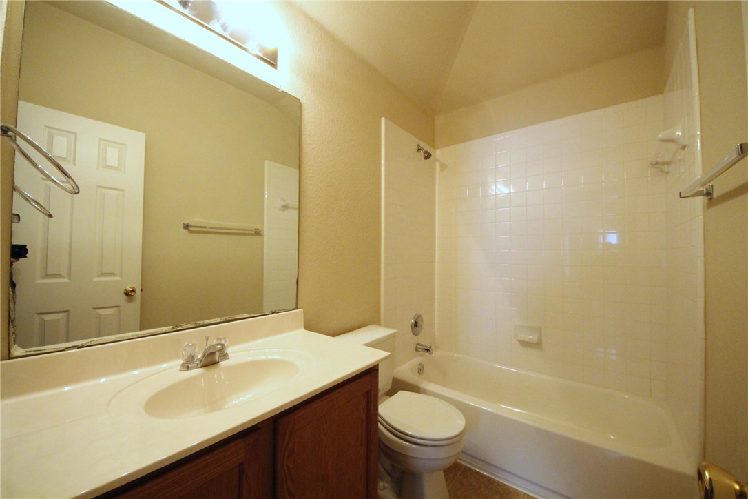 9600 Magna Carta Loop, Unit 177 Austin, TX 78754 - Photo 21 of 25 a bathroom with a sink mirror toilet and bathtub