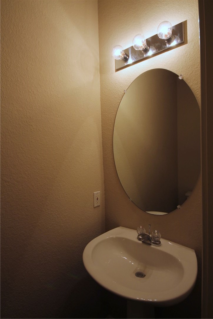 9600 Magna Carta Loop, Unit 177 Austin, TX 78754 - Photo 10 of 25 a bathroom with a sink and mirror