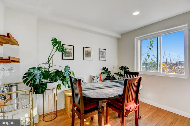 a view of a dining room with furniture and a potted plant
