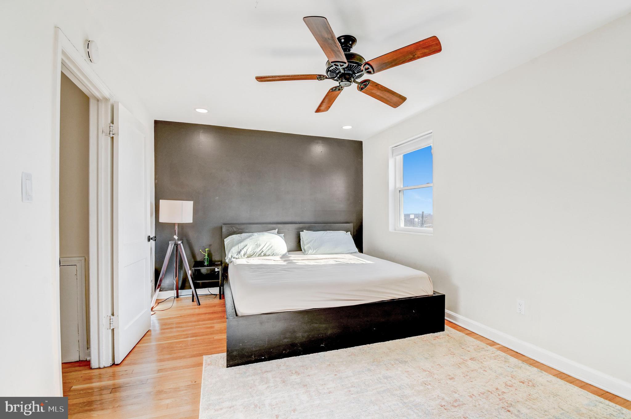 1371 Adams Street Northeast Washington, DC 20018 - Photo 15 of 34 a bedroom with a bed and a chandelier