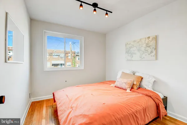 a bedroom with bed and cupboard