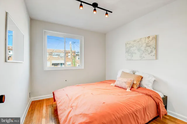 a bedroom with bed and cupboard