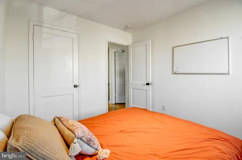 a bedroom with a bed and a painting on the wall