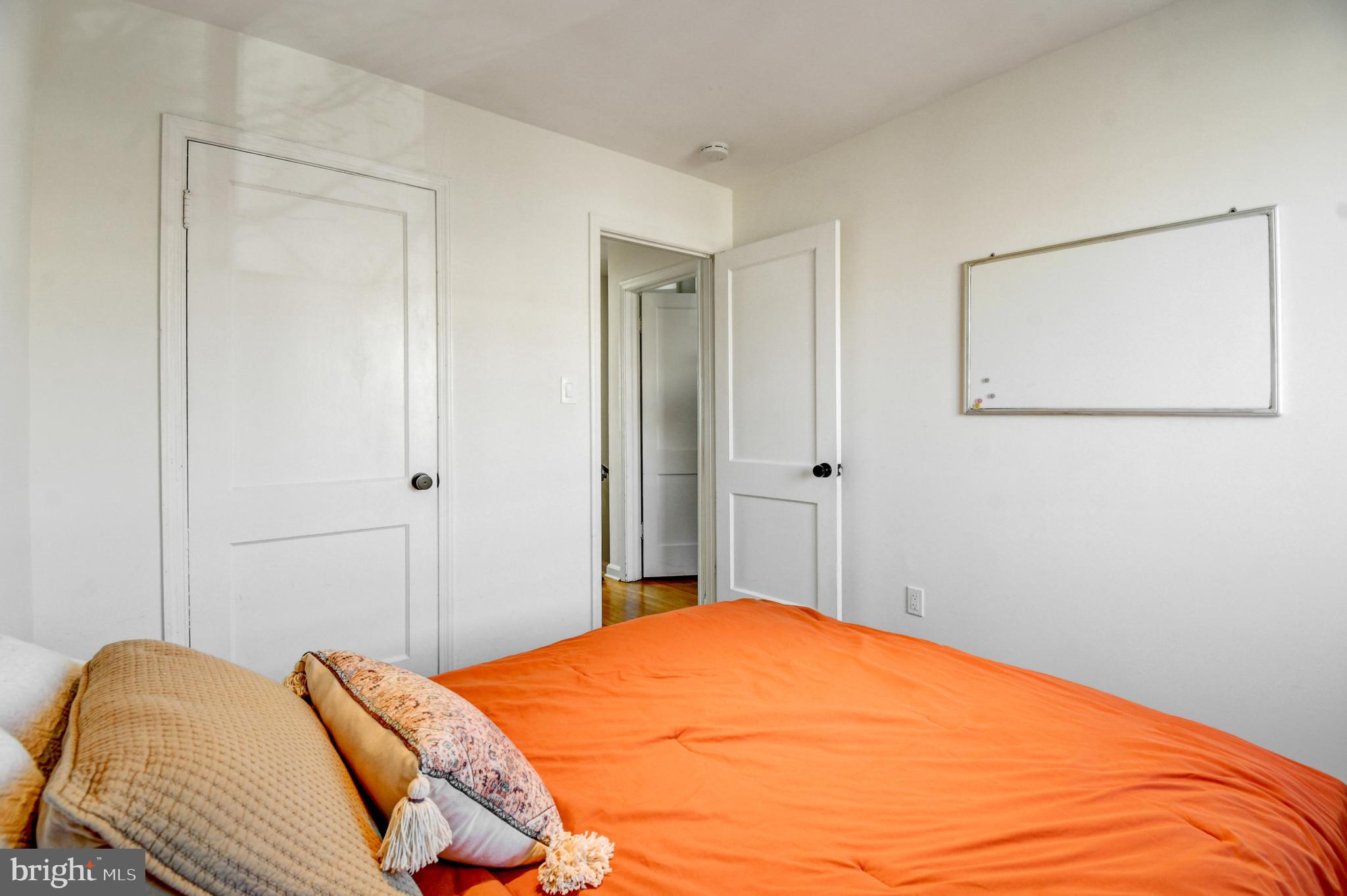 1371 Adams Street Northeast Washington, DC 20018 - Photo 18 of 34 a bedroom with a bed and a painting on the wall