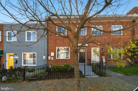 a brick building with a tree in front of it