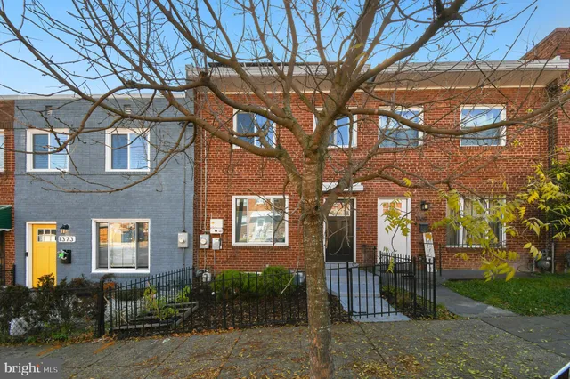 a brick building with a tree in front of it