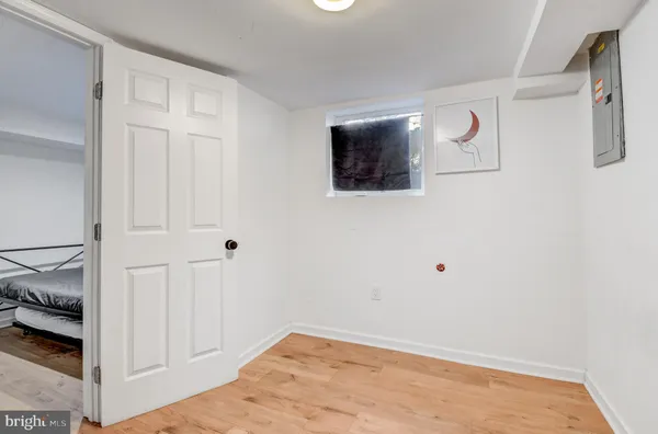 a view of a livingroom with wooden floor and bathroom