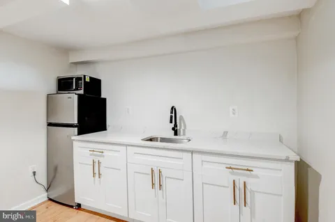 a kitchen with a sink and a refrigerator