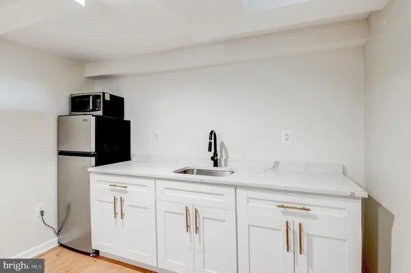a kitchen with a sink and a refrigerator