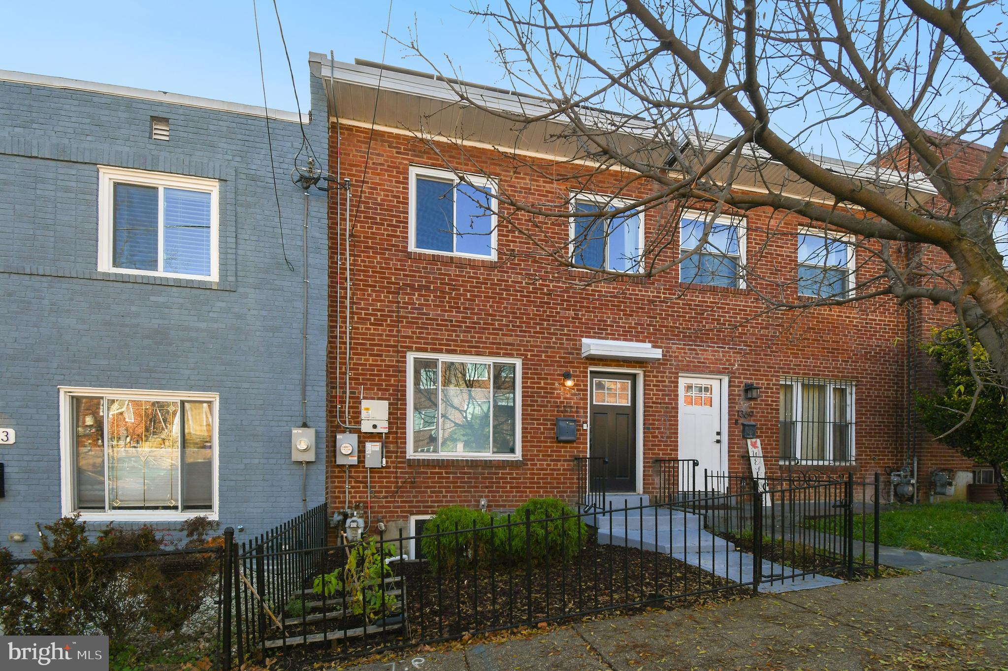 1371 Adams Street Northeast Washington, DC 20018 - Photo 3 of 34 a front view of a house with a garden