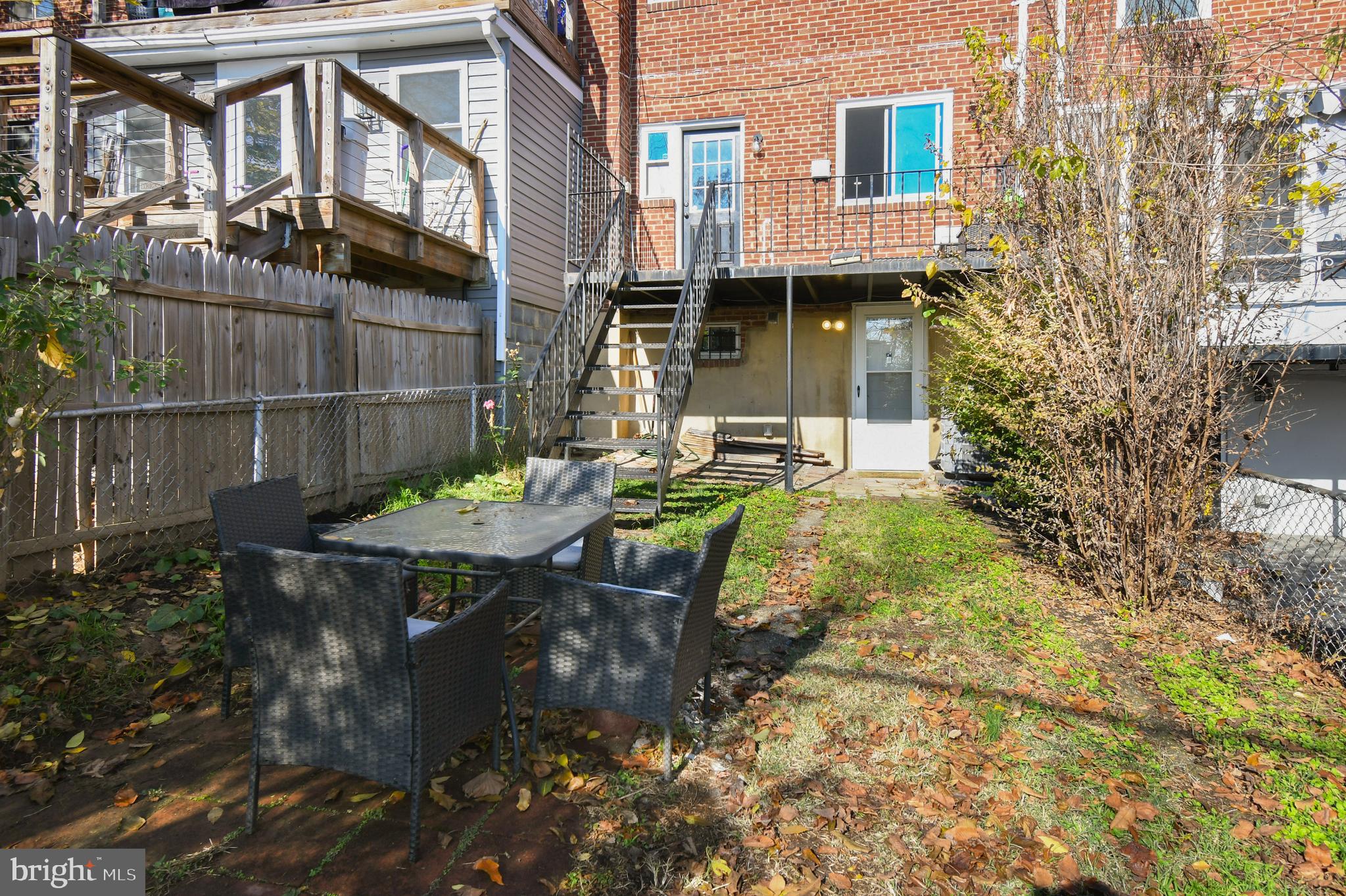 1371 Adams Street Northeast Washington, DC 20018 - Photo 33 of 34 a view of a patio with table and chairs with wooden fence