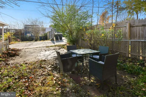 a view of a patio with couches table and chairs and potted plants