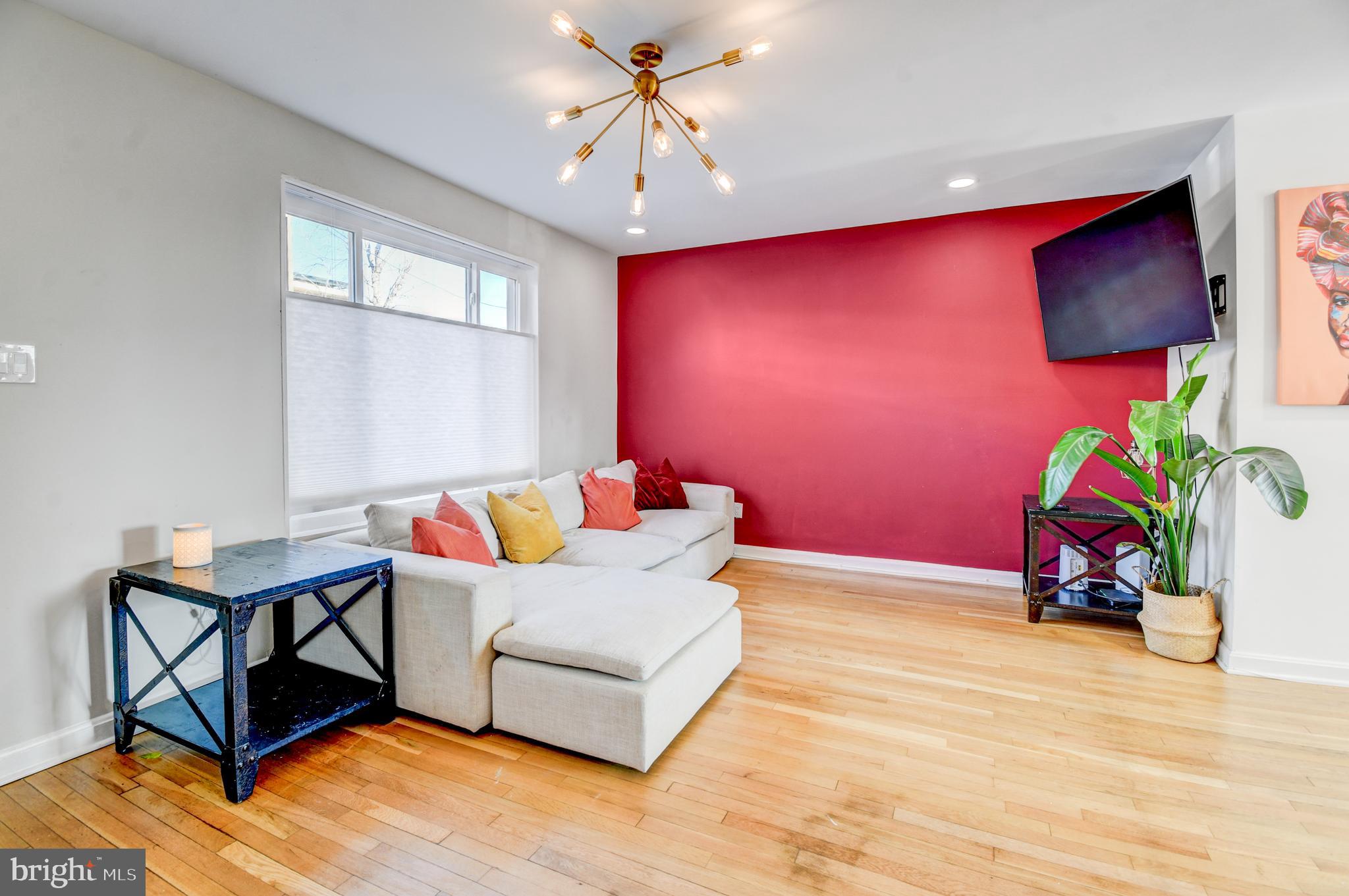 1371 Adams Street Northeast Washington, DC 20018 - Photo 4 of 34 a living room with furniture and a flat screen tv
