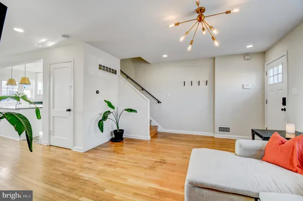 a living room with furniture and a chandelier