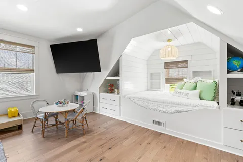 a living room with furniture a large window and flat screen tv