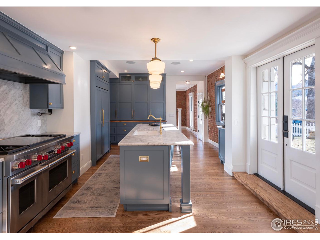 2303 Bluff Street Boulder, CO 80304 - Photo 11 of 40 a kitchen with stainless steel appliances granite countertop a stove a sink dishwasher and a refrigerator with wooden floor