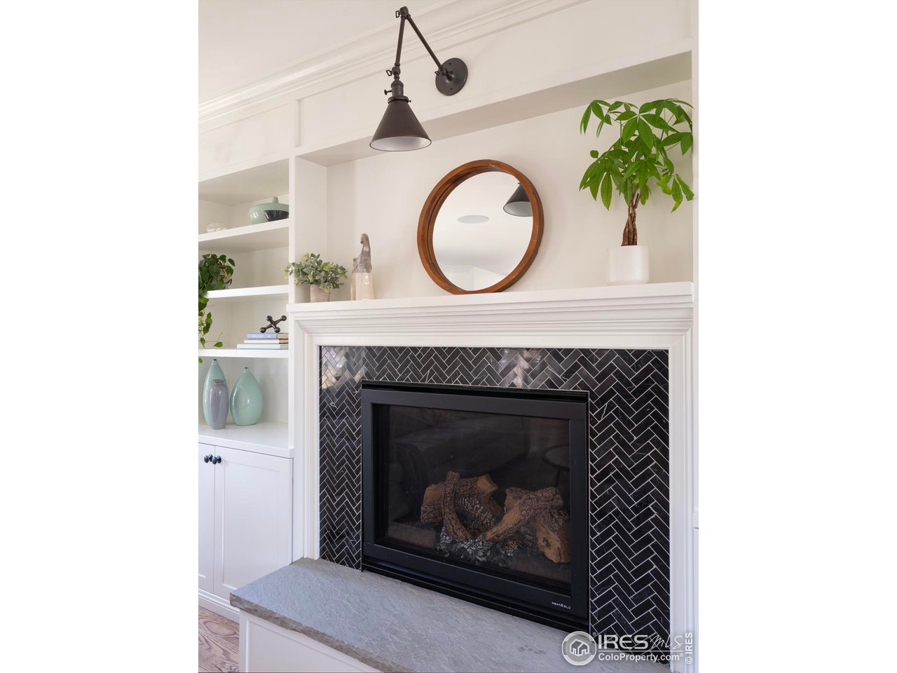 2303 Bluff Street Boulder, CO 80304 - Photo 14 of 40 a living room with a fireplace and a clock