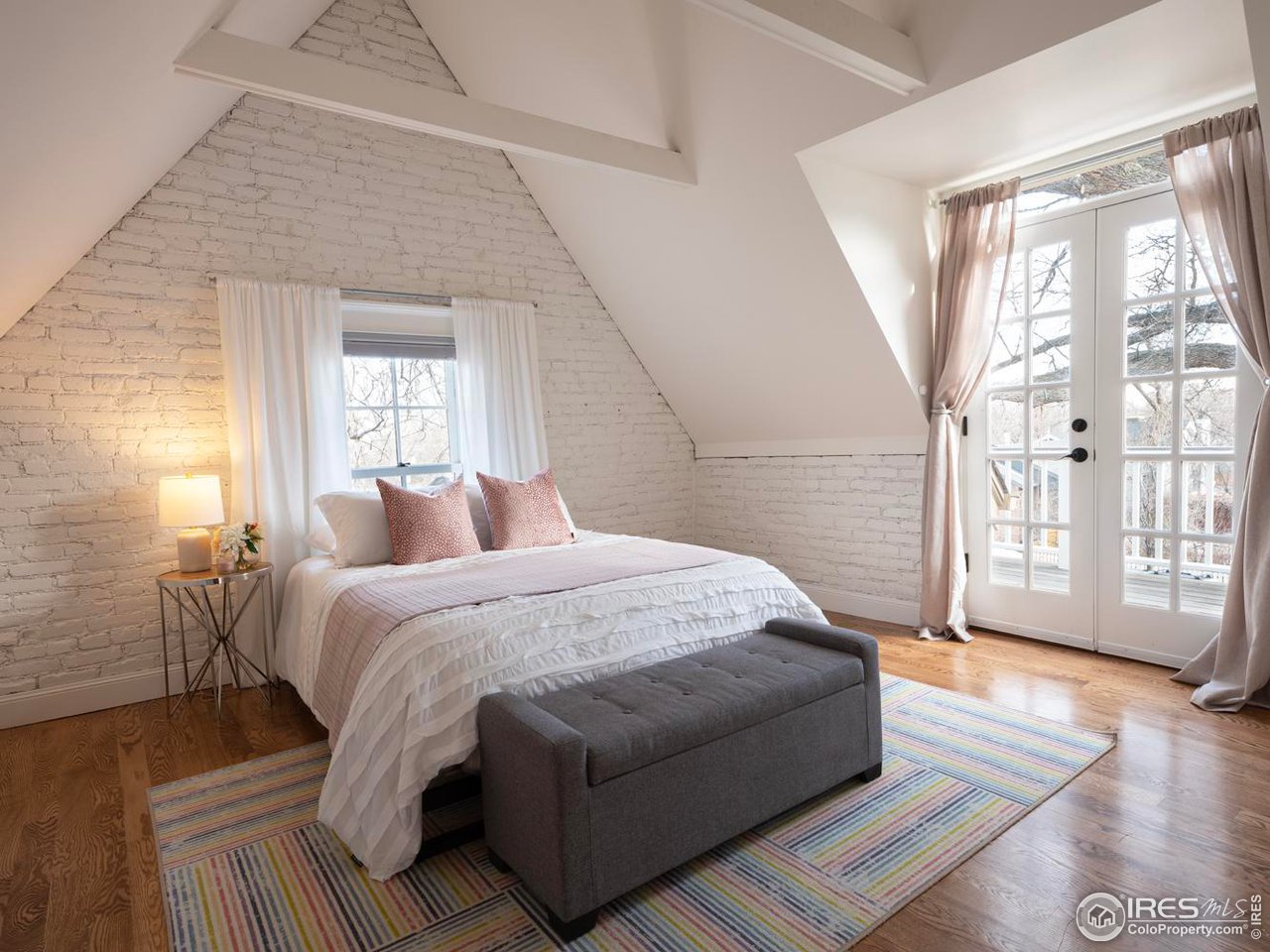 2303 Bluff Street Boulder, CO 80304 - Photo 25 of 40 a spacious bedroom with a bed a couch and windows