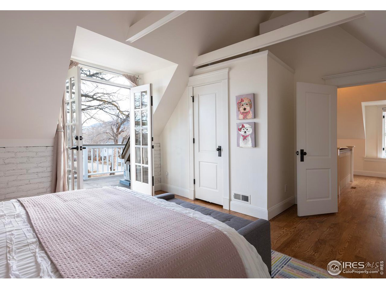 2303 Bluff Street Boulder, CO 80304 - Photo 26 of 40 a bedroom with a large bed and a chandelier