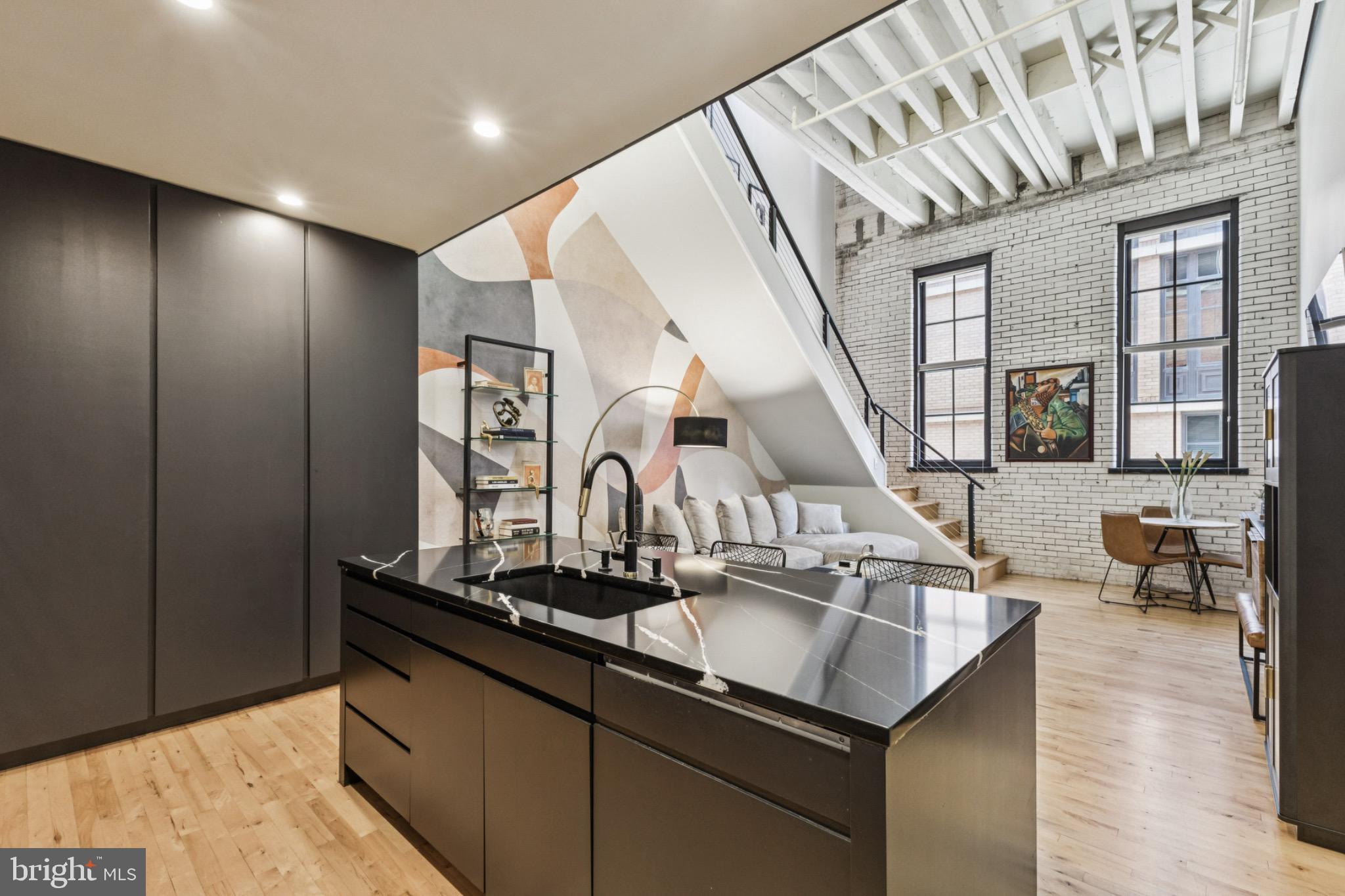 437 New York Avenue Northwest, Unit Y26 Washington, DC 20001 - Photo 3 of 15 a kitchen with stainless steel appliances granite countertop a sink and a wooden floors