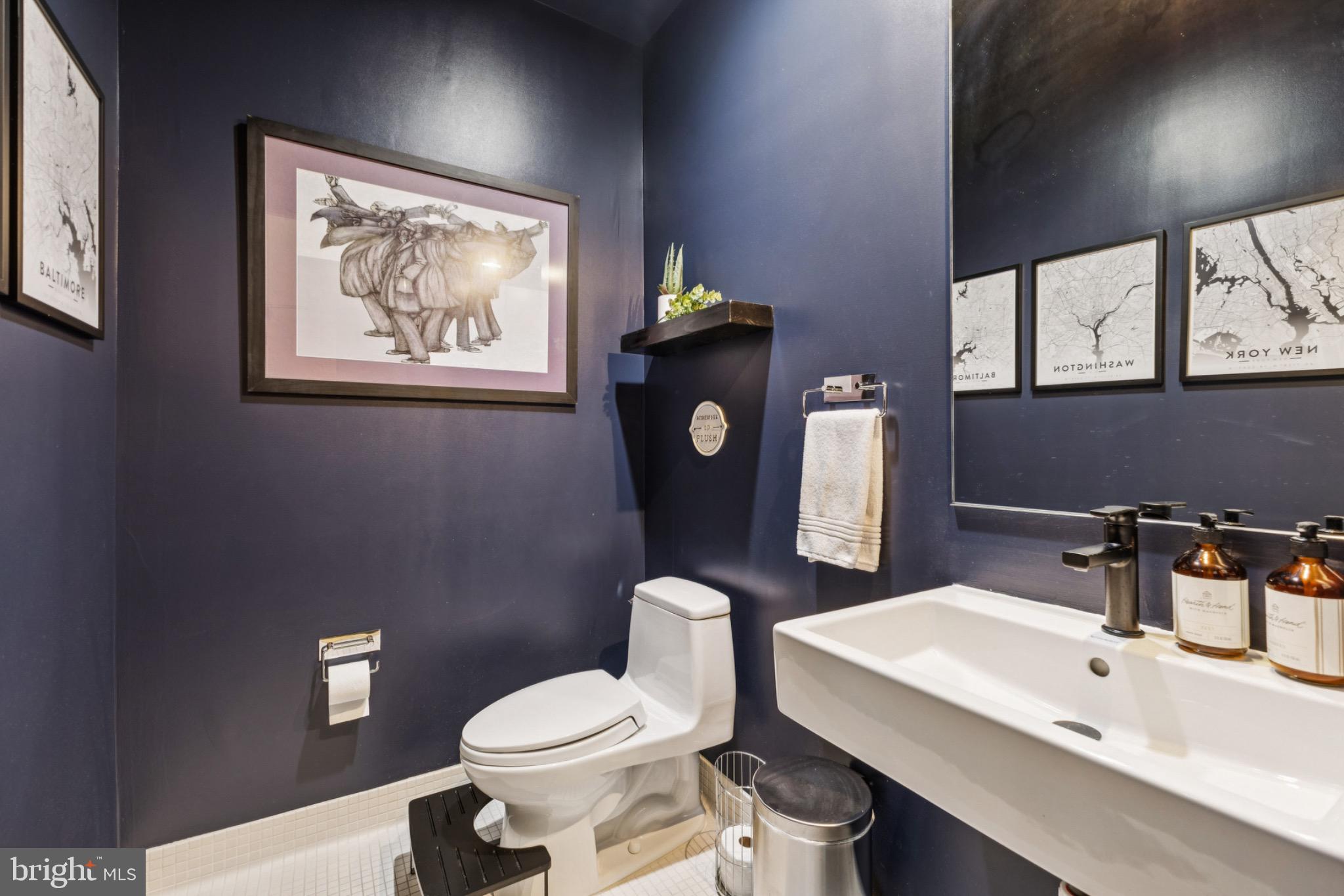 437 New York Avenue Northwest, Unit Y26 Washington, DC 20001 - Photo 7 of 15 a bathroom with a toilet a sink and mirror