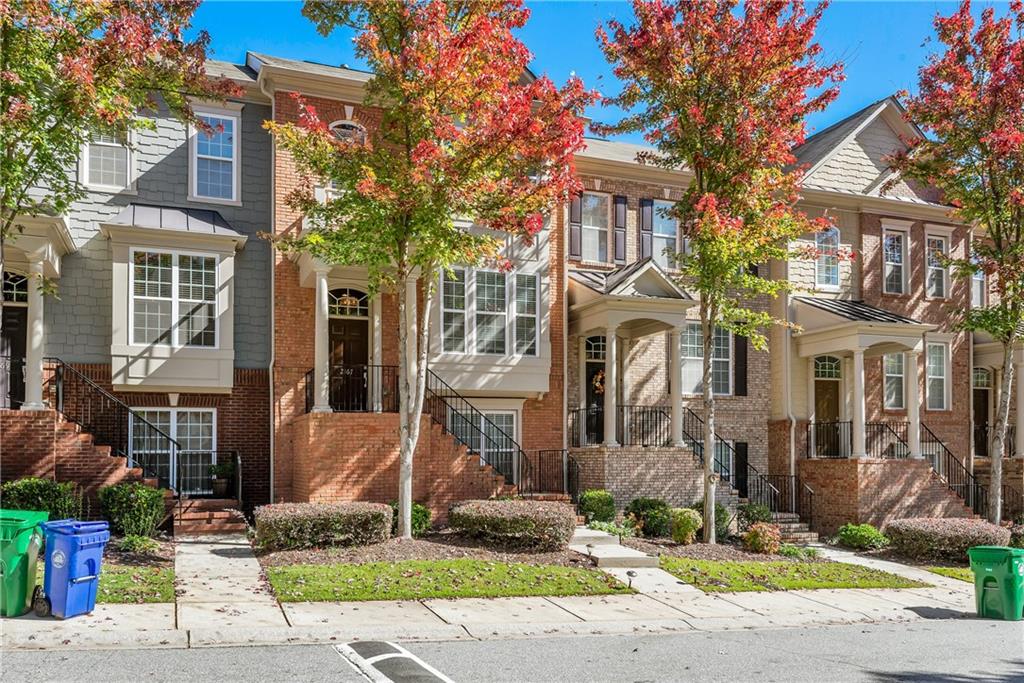 a front view of a brick house with a yard