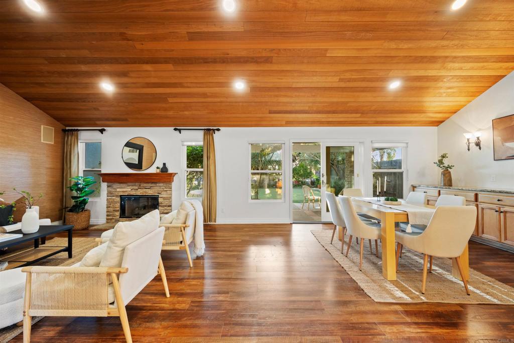 1062 Monterey Vista Way Encinitas, CA 92024 - Photo 18 of 70 a view of a dining room with furniture a fireplace and wooden floor