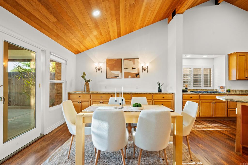1062 Monterey Vista Way Encinitas, CA 92024 - Photo 20 of 70 a view of a dining room with furniture a chandelier and wooden floor