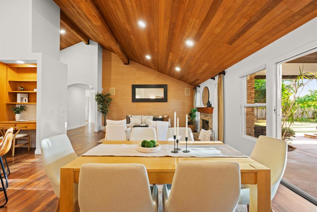 1062 Monterey Vista Way Encinitas, CA 92024 - Photo 23 of 70 a dining room with furniture a large window and wooden floor