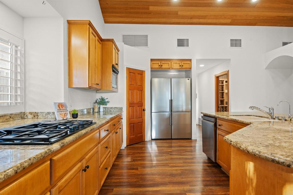 1062 Monterey Vista Way Encinitas, CA 92024 - Photo 25 of 70 a kitchen with granite countertop wooden cabinets and stainless steel appliances
