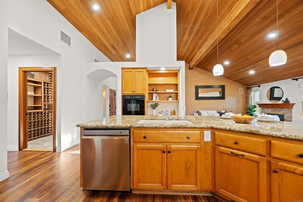 1062 Monterey Vista Way Encinitas, CA 92024 - Photo 30 of 70 a kitchen with granite countertop wooden cabinets and white appliances
