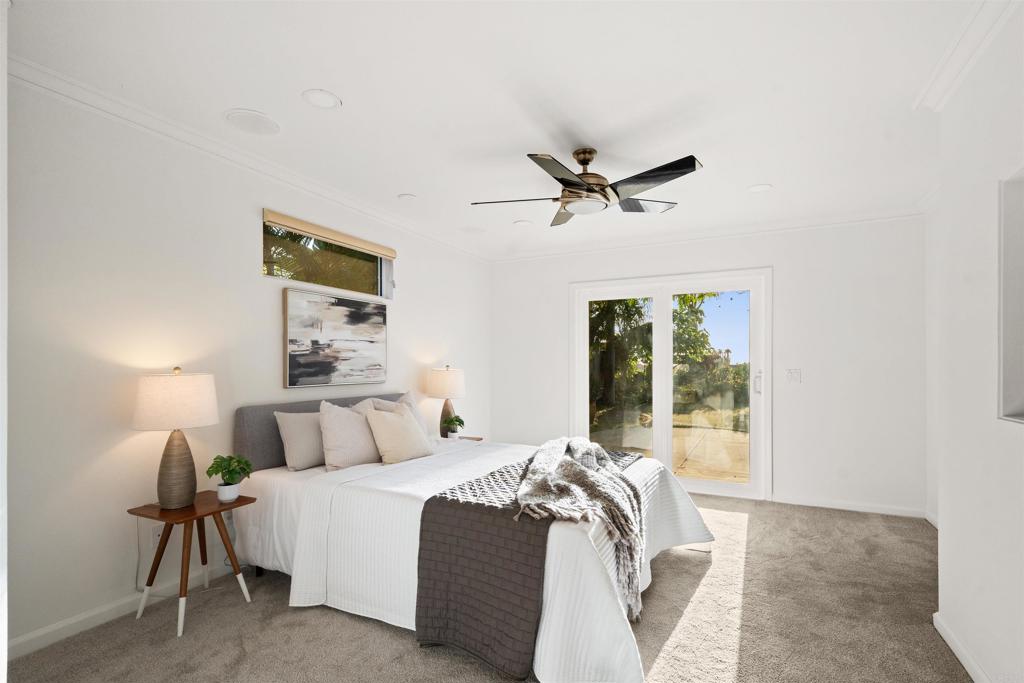 1062 Monterey Vista Way Encinitas, CA 92024 - Photo 43 of 70 a bedroom with a large bed and a ceiling fan