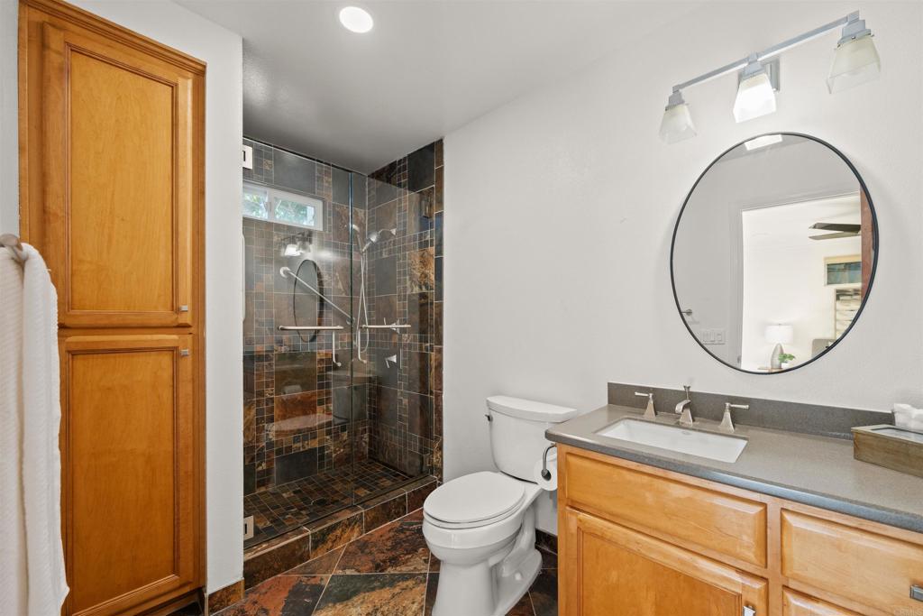1062 Monterey Vista Way Encinitas, CA 92024 - Photo 46 of 70 a bathroom with a granite countertop toilet sink shower and mirror