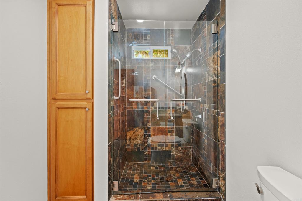 1062 Monterey Vista Way Encinitas, CA 92024 - Photo 47 of 70 a bathroom with a glass shower door