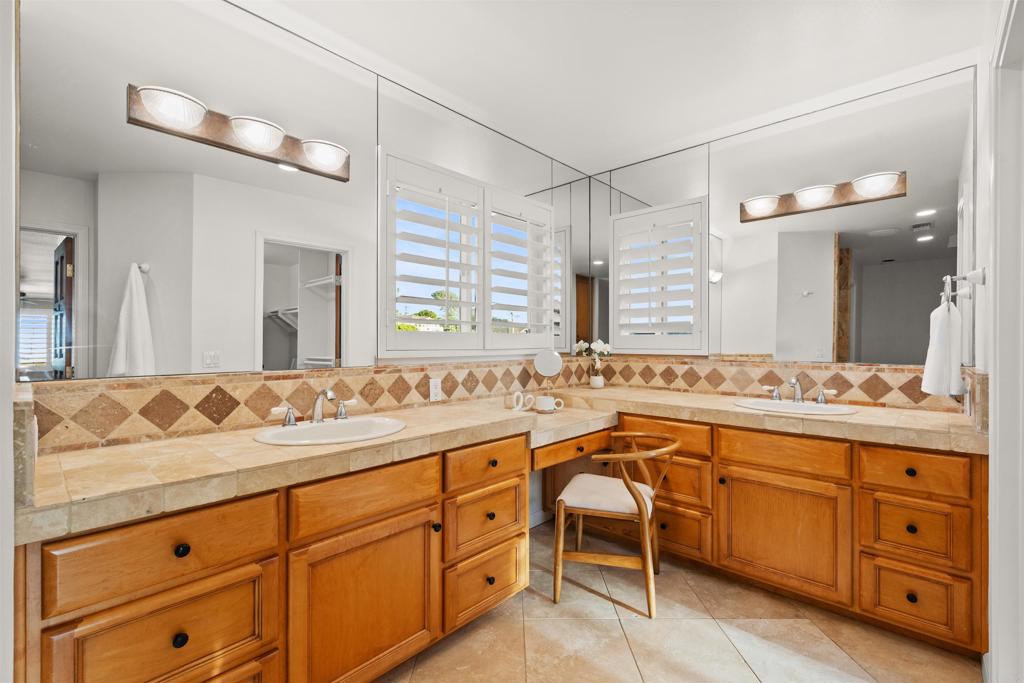 1062 Monterey Vista Way Encinitas, CA 92024 - Photo 56 of 70 a bathroom with a granite countertop sink mirror and