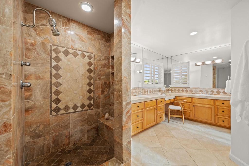 1062 Monterey Vista Way Encinitas, CA 92024 - Photo 58 of 70 a large bathroom with a granite countertop double vanity sink a mirror a bathtub and shower