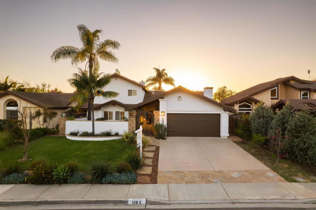 1062 Monterey Vista Way Encinitas, CA 92024 - Photo 67 of 70 a front view of a house with a yard and garage