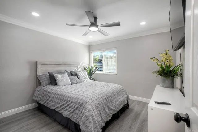 a bedroom with a bed and a tv on table