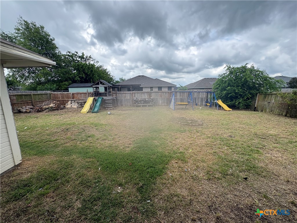 206 Timber Ridge Drive Nolanville, TX 76559 - Photo 21 of 21 a view of a yard with a slide and a tree