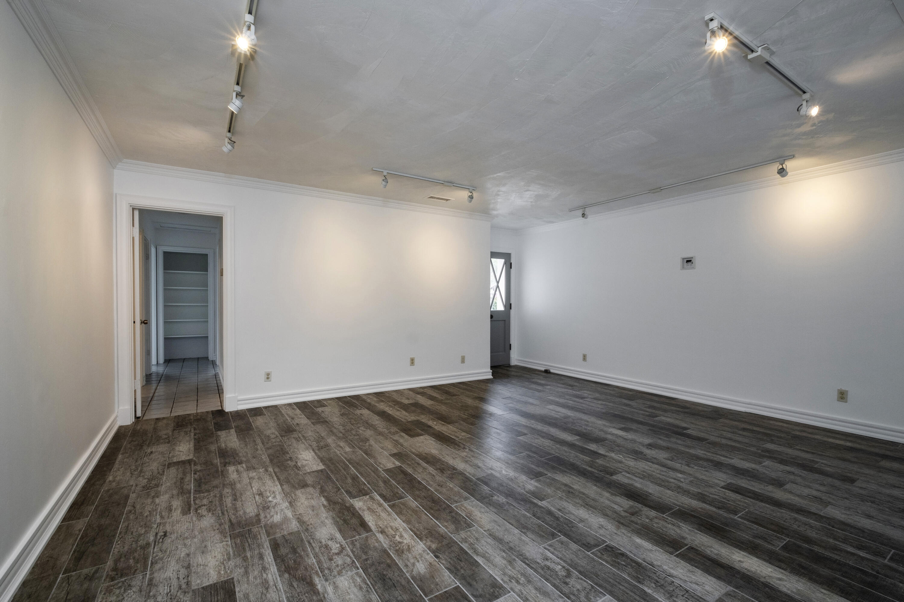 2530 Murrell Road Santa Barbara, CA 93109 - Photo 3 of 19 an empty room with wooden floor and windows