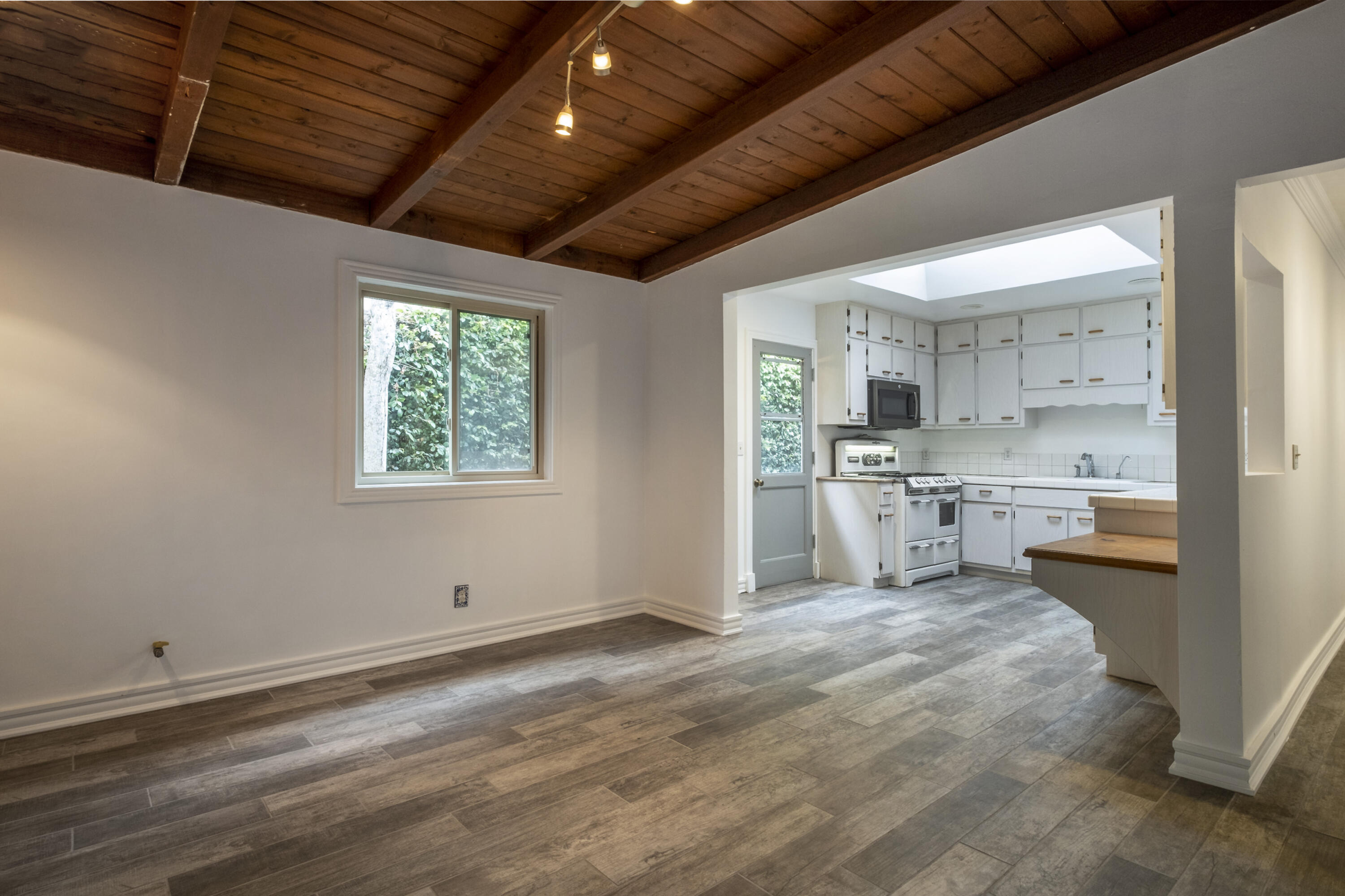 2530 Murrell Road Santa Barbara, CA 93109 - Photo 4 of 19 a kitchen with stainless steel appliances kitchen island granite countertop a sink window and cabinets